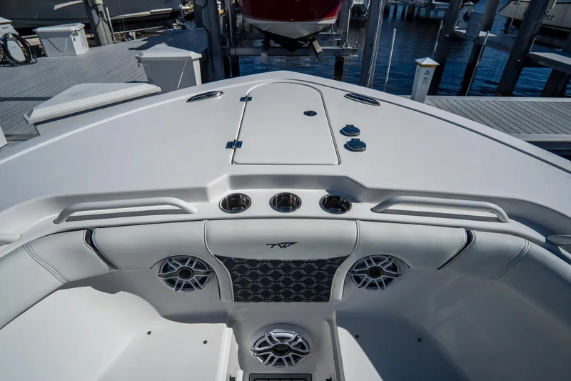Slide: The Image of 2022 Tidewater 292CC Adventure boat interior with speakers and seating at the dock. - 44