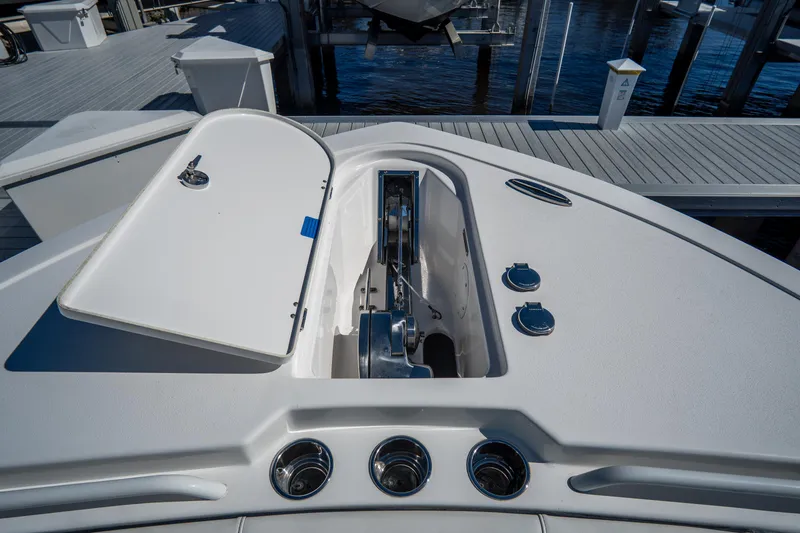 Slide: The Image of 2022 Tidewater 292CC Adventure boat anchor compartment with open hatch at marina. - 45