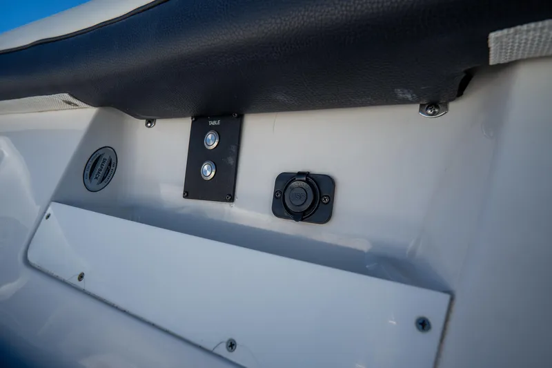 Slide: The Image of 2022 Tidewater 292CC Adventure boat dashboard with controls and outlets. - 46