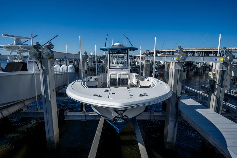 Slide: The Image of 2022 Tidewater 292CC Adventure boat docked at a marina. - 5