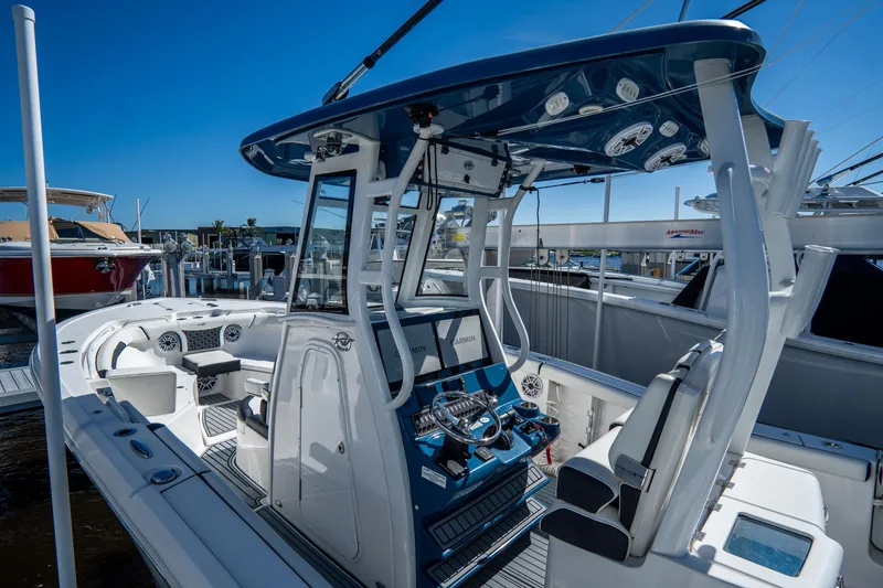 Slide: The Image of 2022 Tidewater 292CC Adventure boat interior with modern console and seating. - 7
