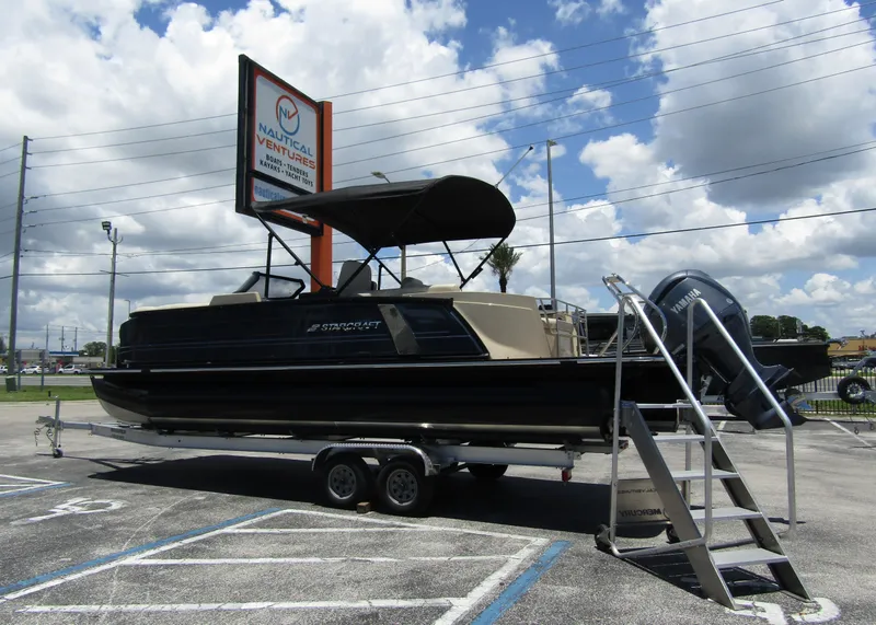 Slide: The Image of 2024 Starcraft RX 23 Q DC pontoon boat on trailer at dealership. - 1