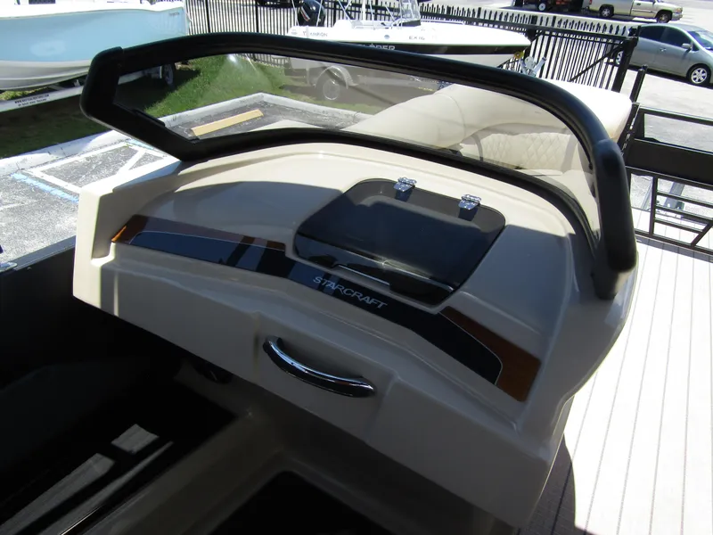 Slide: The Image of 2024 Starcraft RX 23 Q DC boat dashboard with steering wheel and controls. - 13