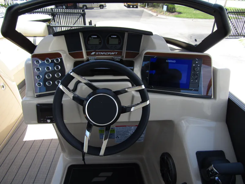 Slide: The Image of 2024 Starcraft RX 23 Q DC boat dashboard with steering wheel and navigation system. - 16