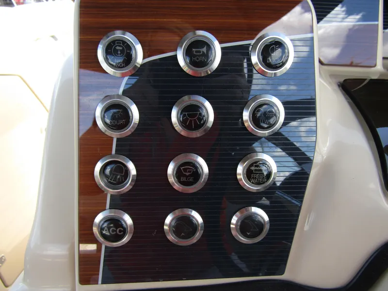 Slide: The Image of Control panel of 2024 Starcraft RX 23 Q DC boat with various function buttons. - 18