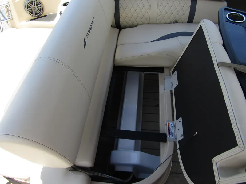 Slide: The Image of 2024 Starcraft RX 23 Q DC boat interior seating with storage compartment. - 25