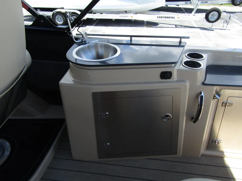 Slide: The Image of 2024 Starcraft RX 23 Q DC boat interior with sink and storage compartments. - 27