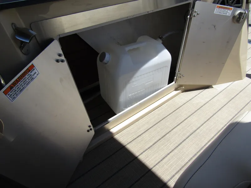 Slide: The Image of 2024 Starcraft RX 23 Q DC storage compartment with a white container. - 29