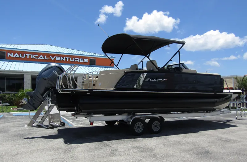 Slide: The Image of 2024 Starcraft RX 23 Q DC boat on trailer at Nautical Ventures dealership. - 3