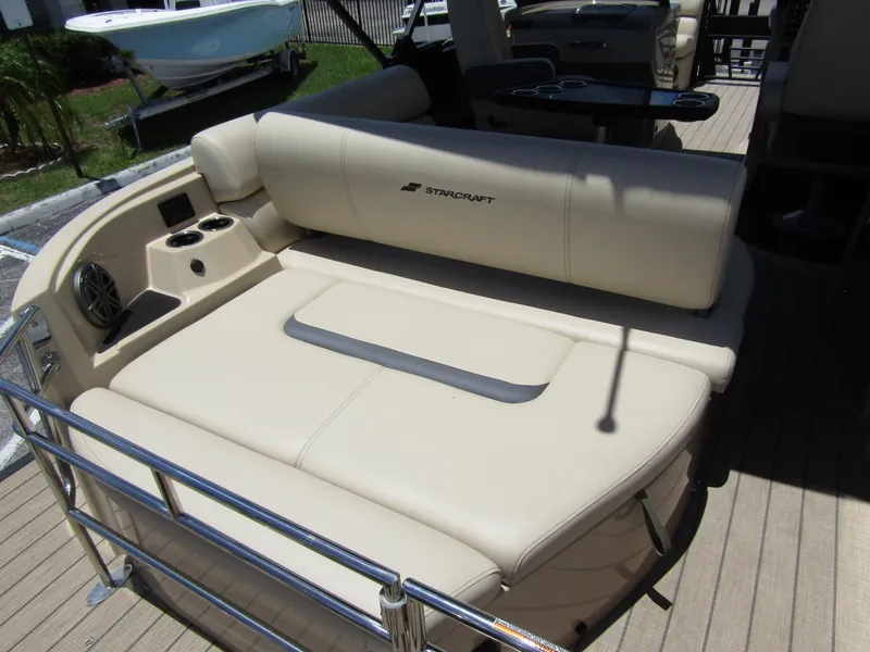 Slide: The Image of 2024 Starcraft RX 23 Q DC boat with beige seating and cup holders. - 30