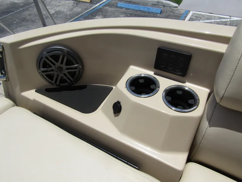 Slide: The Image of 2024 Starcraft RX 23 Q DC boat interior with speaker, cup holders, and control panel. - 33