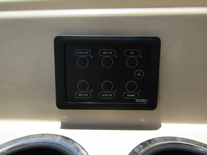 Slide: The Image of Control panel of 2024 Starcraft RX 23 Q DC boat with various light and lift buttons. - 34