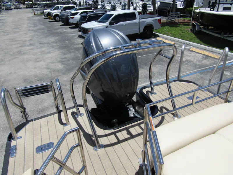 Slide: The Image of 2024 Starcraft RX 23 Q DC boat with outboard motor in parking lot. - 35