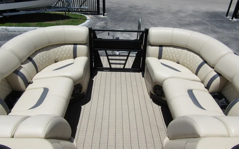 Slide: The Image of 2024 Starcraft RX 23 Q DC boat interior with beige seating and spacious layout. - 9