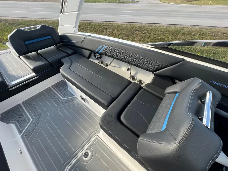 Slide: The Image of 2024 Regal LS6 Surf boat interior with sleek black seating and modern design. - 10