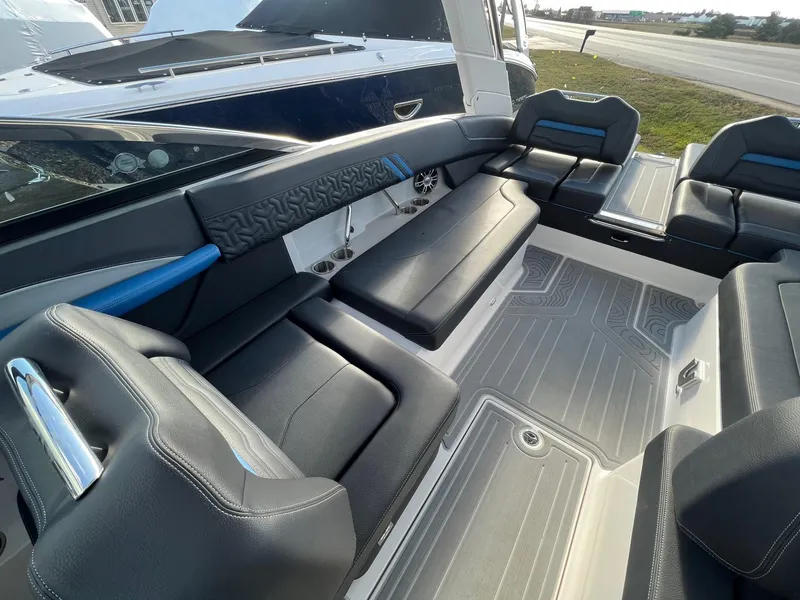 Slide: The Image of 2024 Regal LS6 Surf boat interior with sleek black seating and modern design. - 12