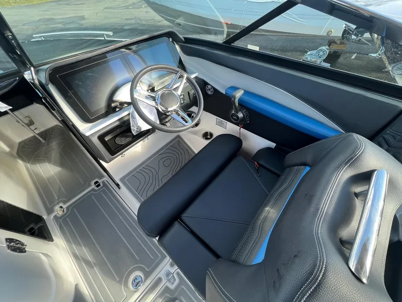 Slide: The Image of 2024 Regal LS6 Surf boat interior with modern dashboard and steering wheel. - 13