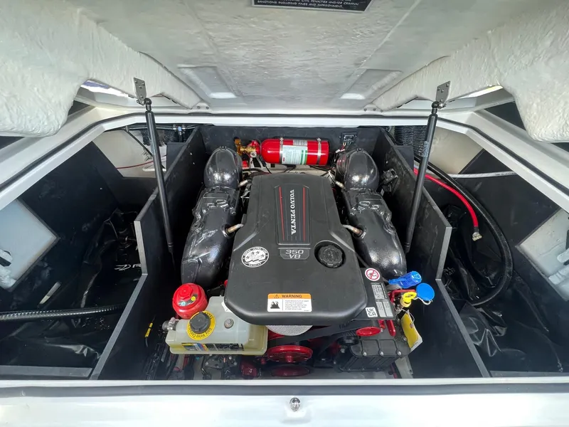 Slide: The Image of 2024 Regal LS6 Surf engine compartment with fire extinguisher and components. - 17