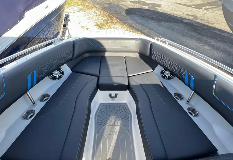 Slide: The Image of 2024 Regal LS6 Surf boat interior with sleek black seating and modern design. - 19