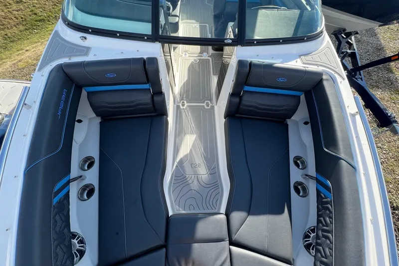 Slide: The Image of 2024 Regal LS6 Surf boat interior with sleek black seating and modern design. - 21