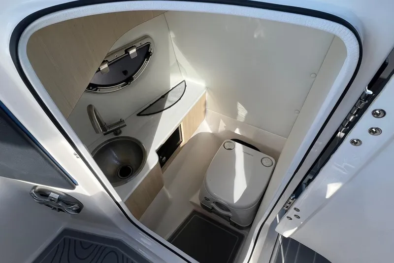 Slide: The Image of 2024 Regal LS6 Surf boat interior bathroom with sink and toilet. - 22