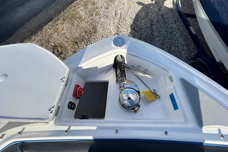 Slide: The Image of 2024 Regal LS6 Surf boat anchor compartment with storage and equipment. - 23