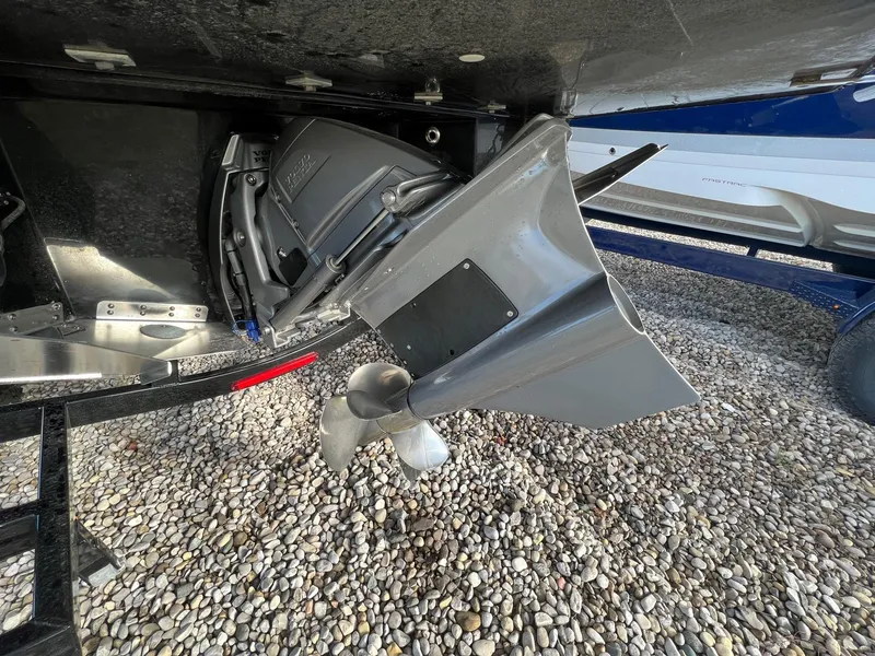 Slide: The Image of 2024 Regal LS6 Surf boat propeller and drive system on gravel surface. - 6