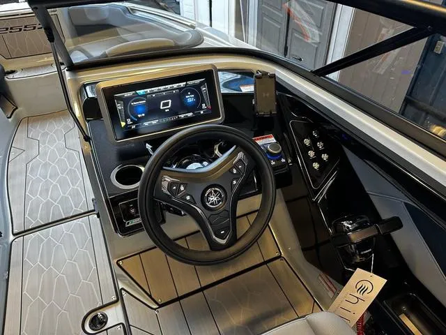 Slide: The Image of 2024 Yamaha Boats 255XD dashboard with touchscreen display and steering wheel. - 12