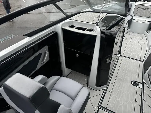 Slide: The Image of 2024 Yamaha Boats 255XD interior cockpit with seating and storage compartments. - 7