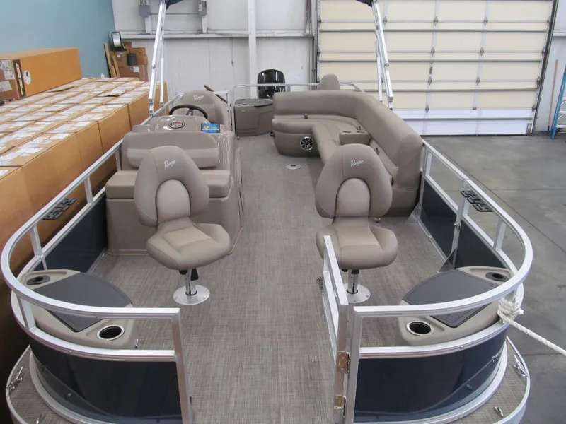 Slide: The Image of 2024 Ranger Reata 200F pontoon boat with spacious seating and modern design in a showroom. - 3
