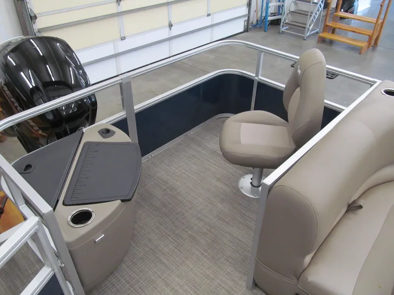 Slide: The Image of 2024 Ranger Reata 200F boat interior with seating and console in a garage setting. - 8