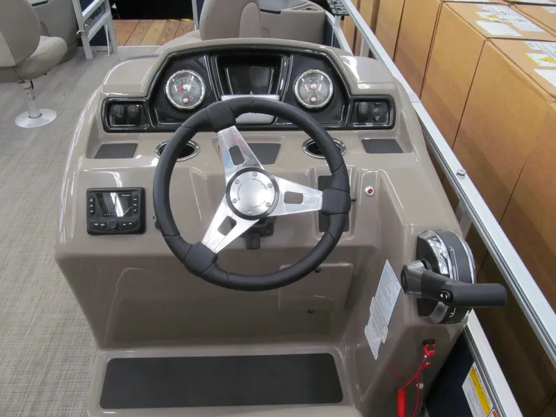 Slide: The Image of 2024 Ranger Reata 200F boat dashboard with steering wheel and controls. - 9