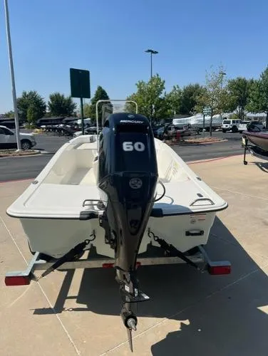 Slide: The Image of 2024 Mako Pro Skiff 15 CC with Mercury 60 engine, parked outdoors. - 3