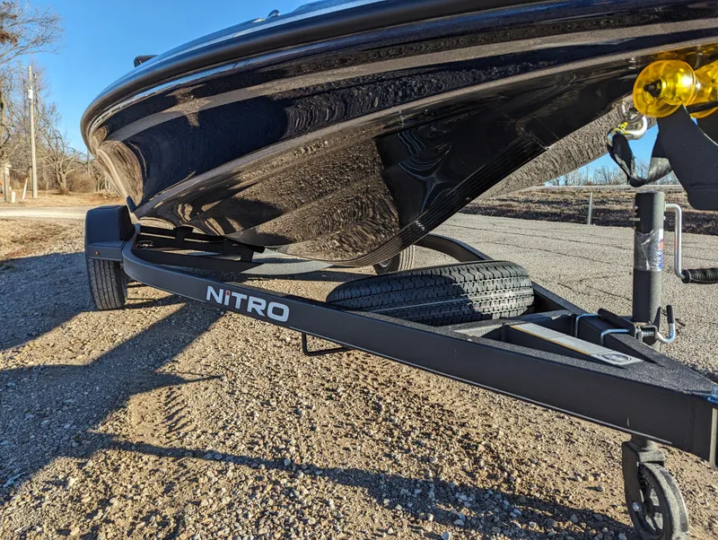 Slide: The Image of 2024 Nitro Z18 Pro boat on trailer, parked on gravel road. - 10