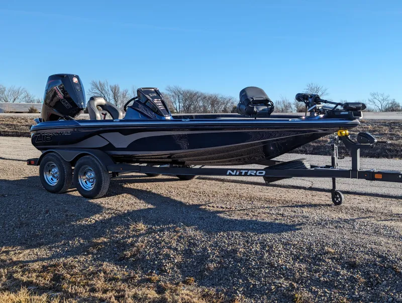 Slide: The Image of 2024 Nitro Z18 Pro boat on trailer, parked outdoors under clear blue sky. - 8