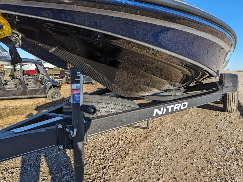 Slide: The Image of 2024 Nitro Z18 Pro boat on trailer, parked on gravel. - 9