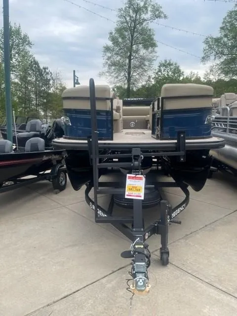 Slide: The Image of 2023 Regency 250 DL3 pontoon boat on display outdoors. - 2