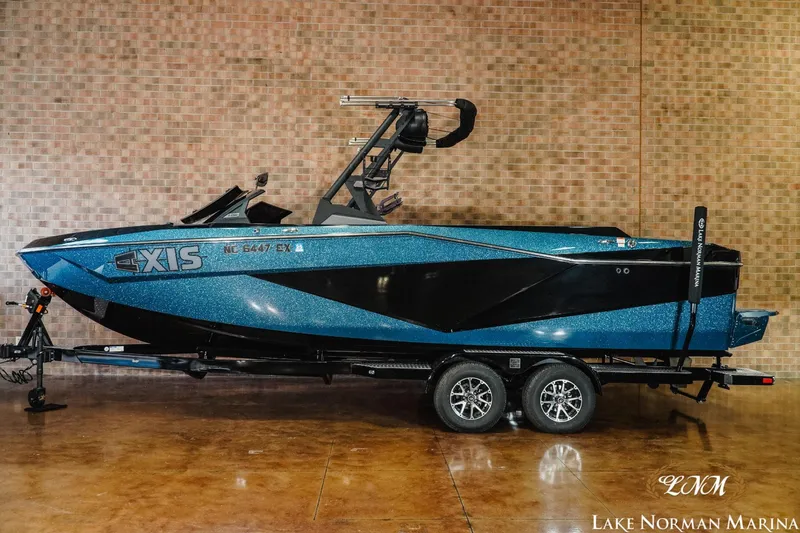 Slide: The Image of 2022 Axis T250 boat in blue and black on a trailer at Lake Norman Marina. - 1