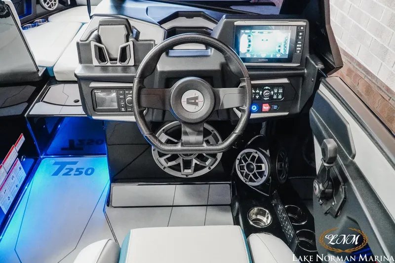 Slide: The Image of 2022 Axis T250 boat dashboard with steering wheel, touchscreen display, and illuminated controls at Lake Norman Marina. - 10