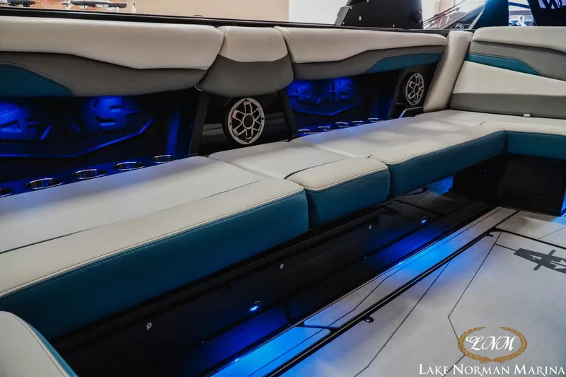 Slide: The Image of 2022 Axis T250 boat interior with blue LED lighting and cushioned seating at Lake Norman Marina. - 16