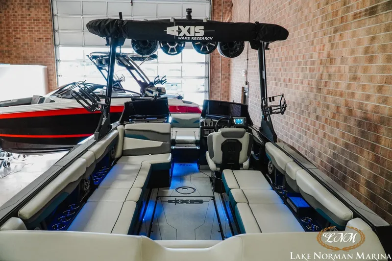Slide: The Image of 2022 Axis T250 boat interior at Lake Norman Marina, featuring spacious seating and modern amenities. - 6