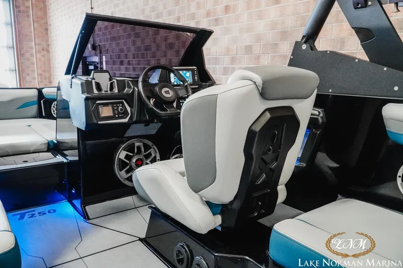 Slide: The Image of Interior of a 2022 Axis T250 boat with modern dashboard and seating. - 9