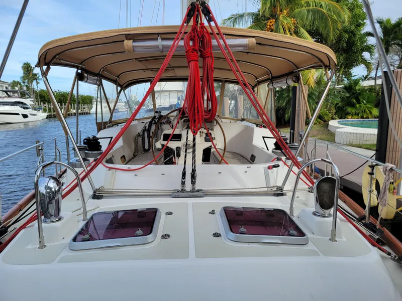 Slide: The Image of Taswell 58 sailboat cockpit, 2003 model, docked with canopy and red ropes, tropical setting. - 10
