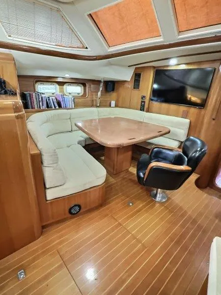Slide: The Image of Luxurious 2003 Taswell 58 yacht interior with plush seating and elegant wood finishes. - 15