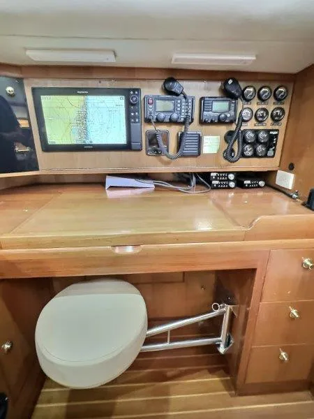 Slide: The Image of Navigation station in 2003 Taswell 58 yacht with electronic equipment and wooden cabinetry. - 25