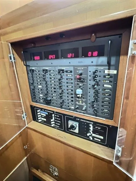 Slide: The Image of Electrical control panel on a 2003 Taswell 58 yacht, featuring switches and digital displays. - 26