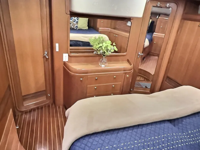 Slide: The Image of Luxurious 2003 Taswell 58 yacht interior with elegant wood finish and cozy bedding. - 29