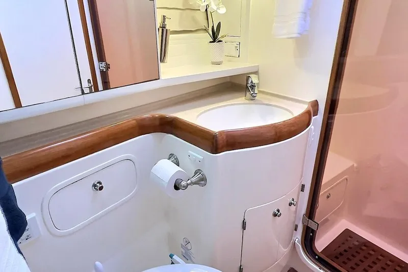 Slide: The Image of Luxurious bathroom in a 2003 Taswell 58 yacht, featuring elegant wood accents and modern fixtures. - 37