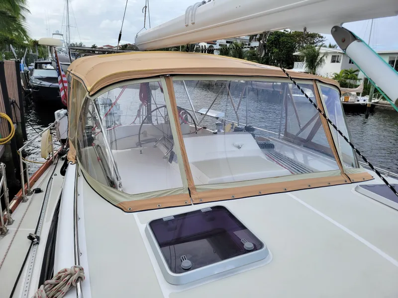 Slide: The Image of Sailboat Taswell 58, 2003 model, docked with tan canopy and clear windows. - 7