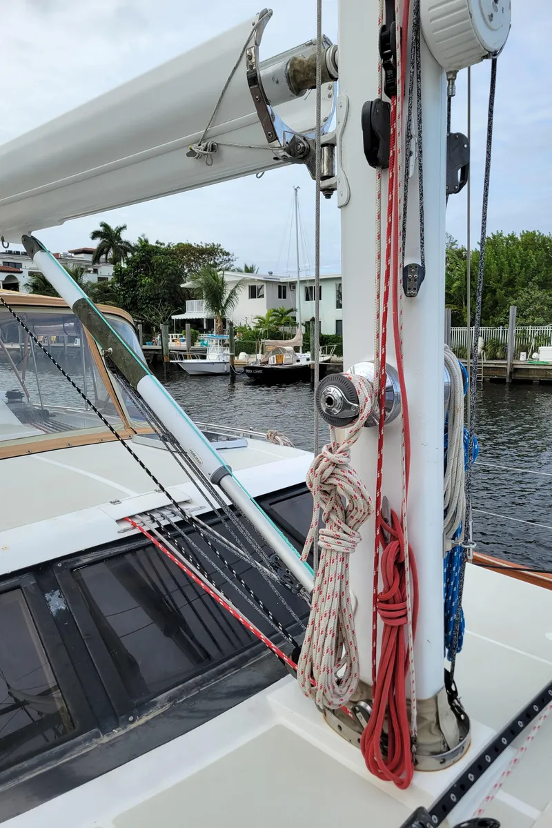 Slide: The Image of 2003 Taswell 58 sailboat deck with mast, ropes, and waterfront view. - 8